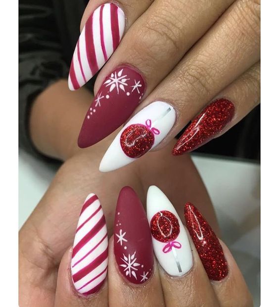 28 Most Beautiful and Elegant Christmas Stiletto Nail Designs; Stiletto nail; red Christmas nails; snowflakes nails; candy cane stripes nails.