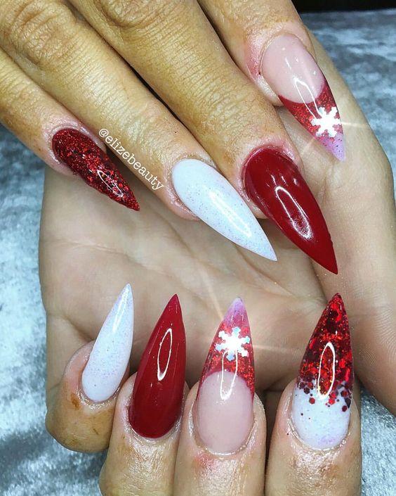 28 Most Beautiful and Elegant Christmas Stiletto Nail Designs; Stiletto nail; red Christmas nails; snowflakes nails; candy cane stripes nails.