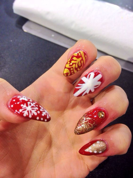 28 Most Beautiful and Elegant Christmas Stiletto Nail Designs; Stiletto nail; red Christmas nails; snowflakes nails; candy cane stripes nails.