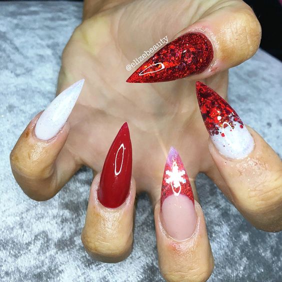 28 Most Beautiful and Elegant Christmas Stiletto Nail Designs; Stiletto nail; red Christmas nails; snowflakes nails; candy cane stripes nails.